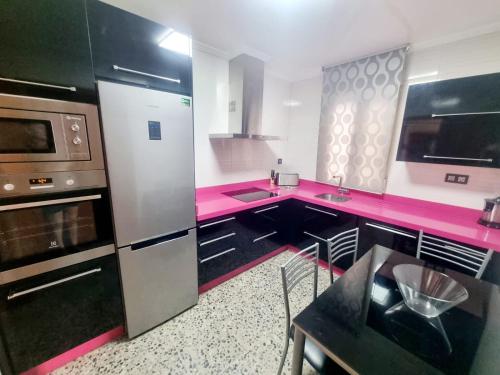 une cuisine avec un comptoir et des appareils roses dans l'établissement CASA MIGUEL, à Puebla de Don Fadrique
