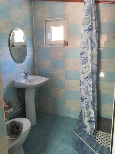 La salle de bains est pourvue d'un lavabo, de toilettes et d'un rideau de douche. dans l'établissement Hotel Diana, à Cahul