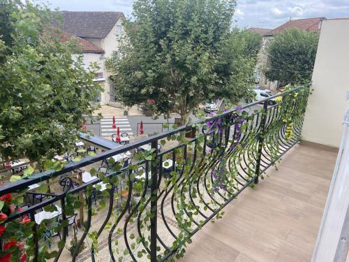 a balcony with a black fence and trees at Chambres n°4 (1-2pers) + Balcon in Prayssac
