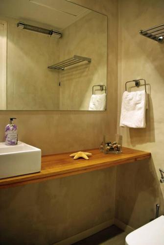 a bathroom with a sink and a mirror at Beach apartment overseeing the sea in Llafranc