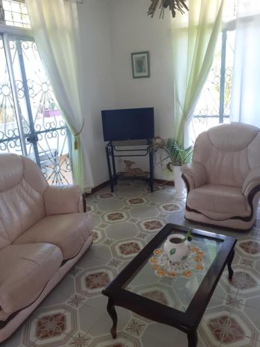 a living room with two couches and a coffee table at La SAISONNIERE in Le Gosier