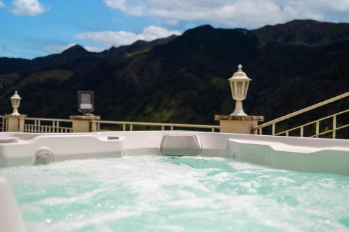 a jacuzzi tub with a view of the mountains at B&B Das Land-Palais - PRIVATE Mountain Hideaway in Selva dei Molini