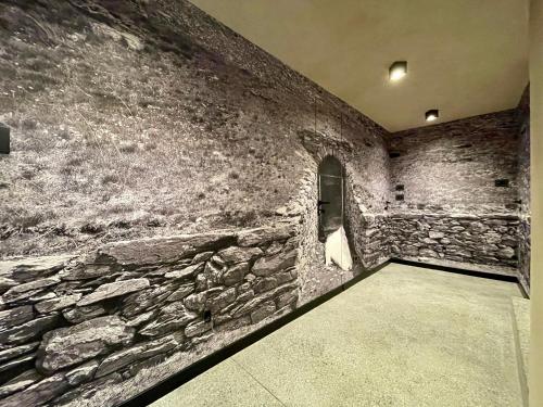 a stone wall in a room with a stone wall at La Rêverie de Thumel - Suite in Rhêmes-Notre-Dame