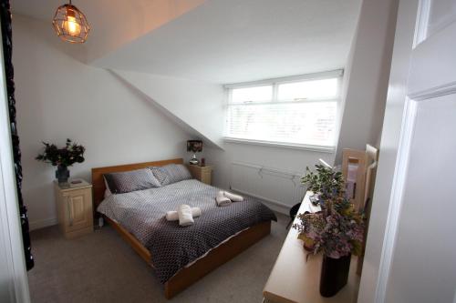 a bedroom with a bed with two teddy bears on it at Lymm Village Apartment in Lymm