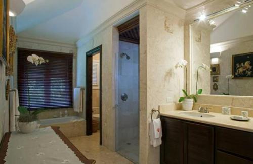 a bathroom with a shower and a sink and a tub at Sunny Vacation Villa No 65 in San Rafael del Yuma