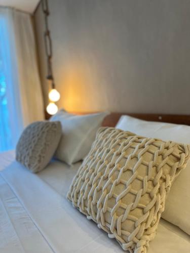 a bed with two pillows on top of it at Hotel da Pipa in Pipa