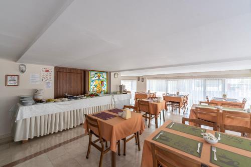 a dining room with wooden tables and chairs at Şehir Hotel in Antalya