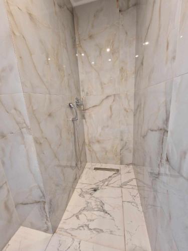 a bathroom with a marble shower with a toilet at Villa Hillside Pefkohori in Pefkochori