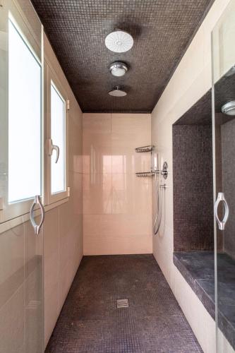 a bathroom with a shower and a glass door at Hotel Il Barocco in Ragusa