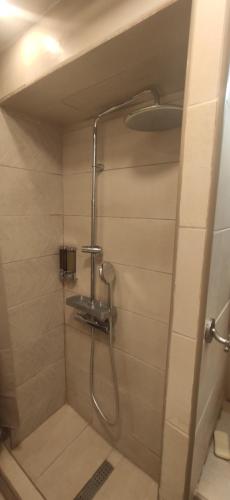 a shower in a bathroom with a shower at Stone apartment in Chalkida