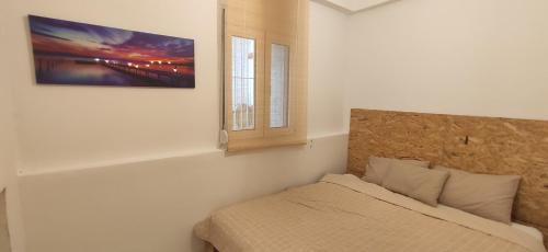 a bedroom with a bed and a window at Stone apartment in Chalkida