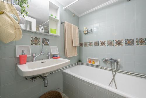 a bathroom with a sink and a bath tub at Sweet home in Koukaki in Athens