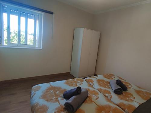 a bedroom with a bed and a refrigerator at Bonjoia Apartments in Porto