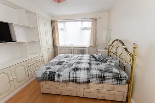 a bedroom with a bed and a window at OAK AVENUE HOME in Shirley