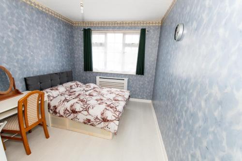 a small bedroom with a bed and a desk at OAK AVENUE HOME in Shirley