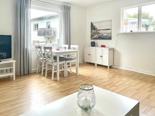 a living room with a table and a dining room at 4 person holiday home in TRENSUM-By Traum in Trensum