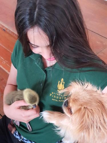 a woman holding a small animal in her arms at Quinta do Pinheiro Hotel E Eventos by Grupo Quinta dos Lagos in Valado dos Frades
