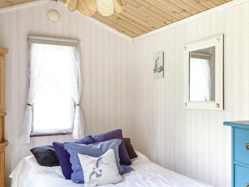 a bedroom with a bed and a window at 4 star holiday home in BLIDÖ-By Traum in Blidö