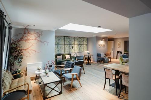 a living room with couches and chairs and tables at The Bonnie Badger in Gullane