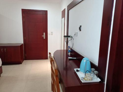 a bathroom with a counter with a sink and a mirror at Hotel Autumn Crocus in Guwahati