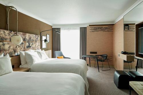 a hotel room with two beds and a desk at London Marriott Hotel Regents Park in London