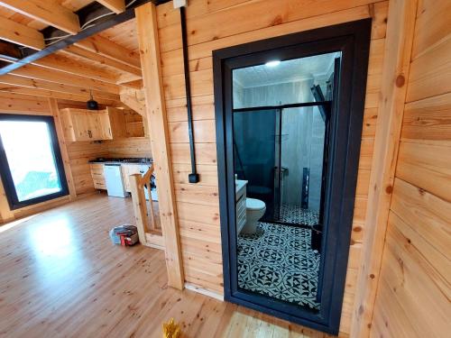 a bathroom with a shower in a wooden cabin at Trabzon Çamlıca Bungalov 2 floors Sea view in Yomra