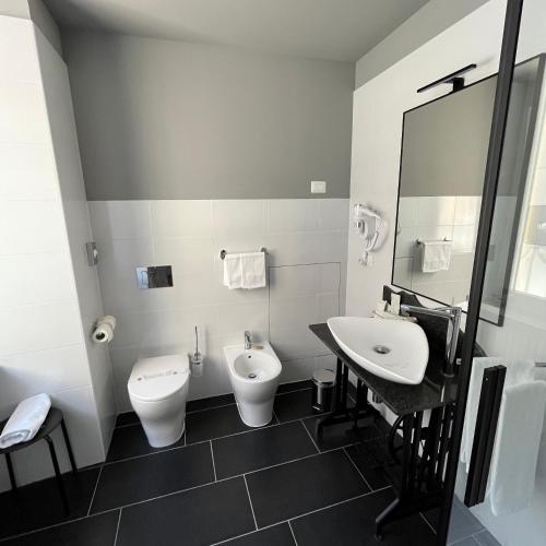 a bathroom with a toilet and a bidet and a sink at Borgo Yporegia in Ivrea