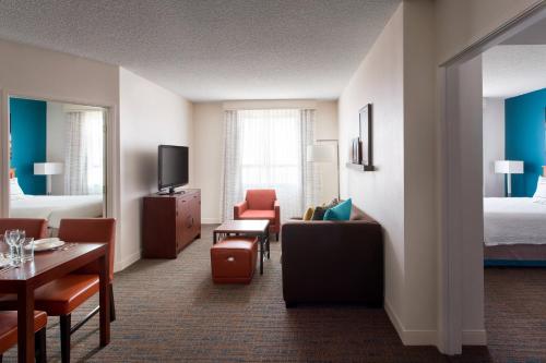a hotel room with a bed and a living room at Residence Inn by Marriott Las Vegas Hughes Center in Las Vegas