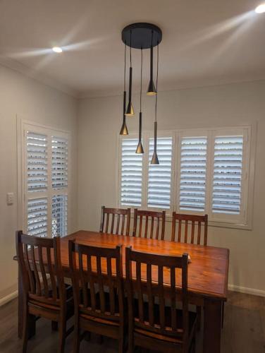 a dining room with a wooden table and chairs at Entire House near Brisbane City 2Beds in Brisbane
