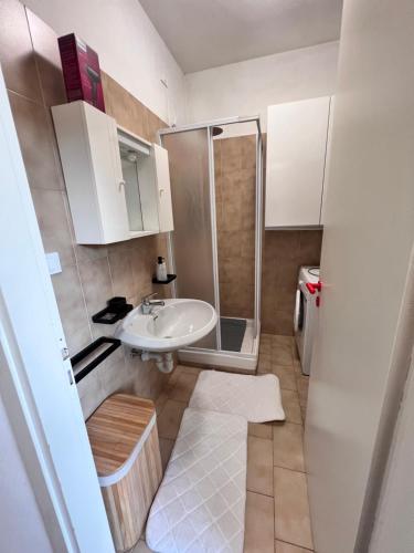 a small bathroom with a sink and a shower at baiasole in Sanremo
