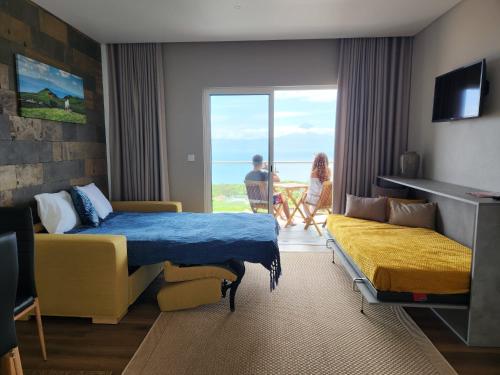 a hotel room with two beds and a view of the ocean at Rosegarden View in Velas