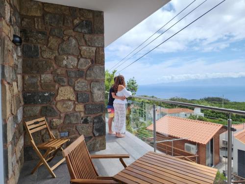 a woman standing on the balcony of a house at Rosegarden View in Velas