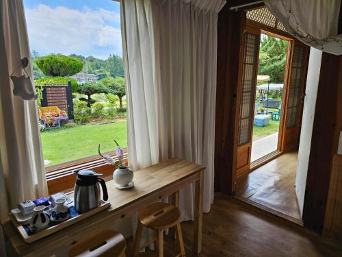 a room with a table and a large window at Damyang Flower & Hanok in Damyang