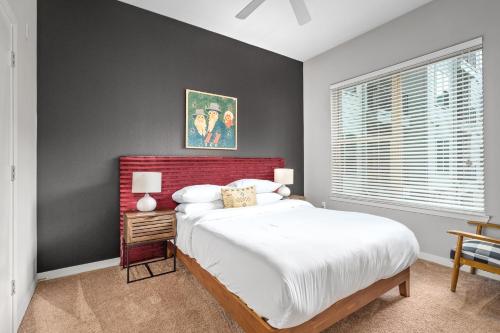 a bedroom with a large bed with a red headboard at Luxury Oasis I Mins from TX Med Center-FREEParking in Houston