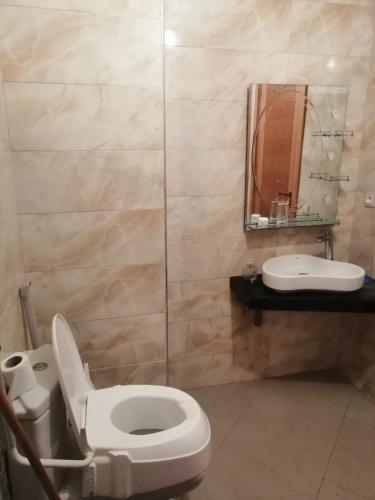 a bathroom with a toilet and a sink at TAMARIs in Tamaris