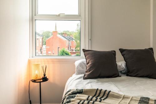 a bedroom with a bed in front of a window at The Broadway Bath - 2 Bedrooms with parking, Central Bath in Bath