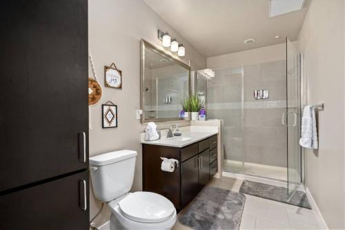 a bathroom with a toilet and a sink and a shower at 1BRModern Retreat-Mins to Med Center in Houston