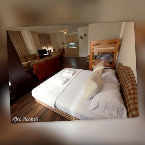 a large bed in a room with a living room at Ajro Rooms in Struga