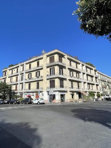 a large building with cars parked in front of it at ISOLA - Smart ApartHotel in Messina
