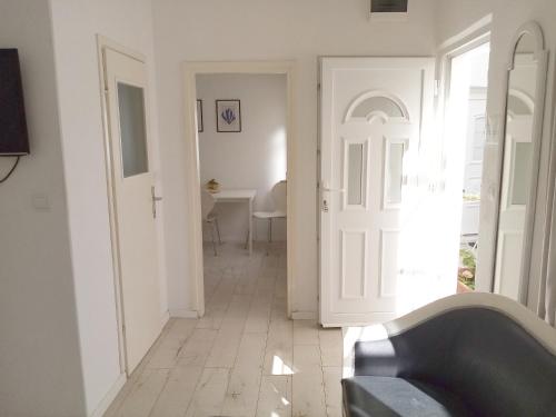 a hallway with a white door and a table at Apartments Emi in Dubrovnik