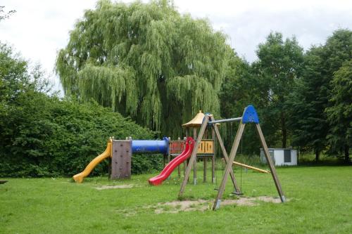 a playground in a park with a slide at Landhaus Schloss Kölzow in Kölzow