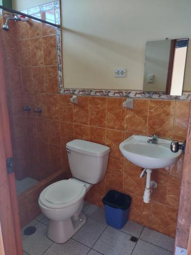 a bathroom with a toilet and a sink at HOTEL SOL Y LUNA in Iquitos
