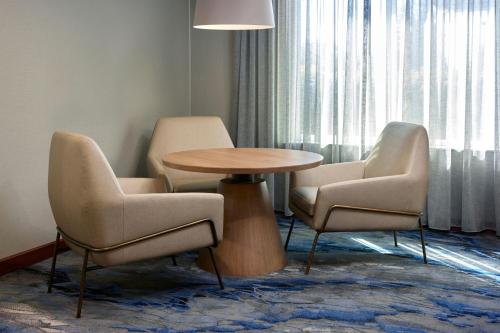 a room with a table and two chairs and a table at Fairfield Inn & Suites Burlington in Burlington