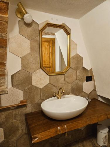 a bathroom with a sink and a mirror at DESTASU' Apartments in Castel del Monte