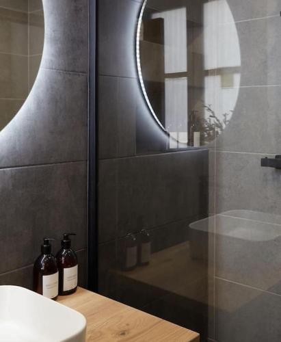 une salle de bain avec une douche, un lavabo et un miroir dans l'établissement Apt design, proche Champs Elysées, à Paris