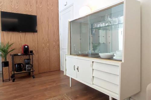 a large white dresser with a glass door at Sweet Domus & Terrace Citycenter in Vila Nova de Famalicão