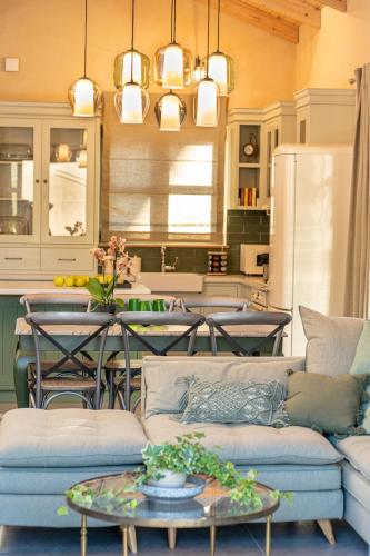 a living room with a couch and a table at Villa Rodamos in Karavomylos