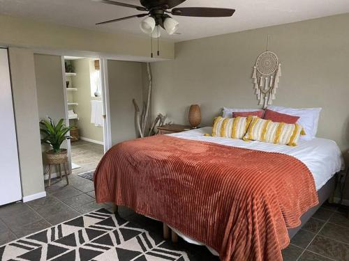 a bedroom with a bed and a ceiling fan at BlueHaven: Your Cozy Lakeside Retreat in Glenn