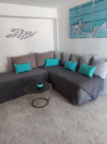 a living room with a couch and a table at Aegean Blue in Panteli