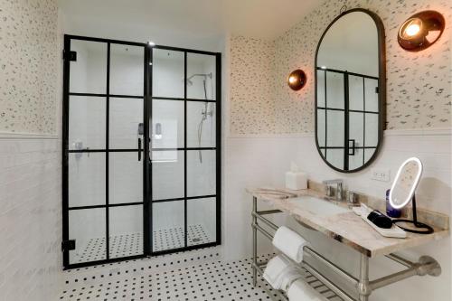 a bathroom with a sink and a mirror at Trilogy Hotel Montgomery, Autograph Collection in Montgomery